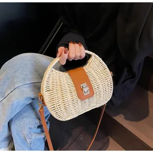 Detail der Bohème-Strohtasche mit brauner Lederklappe und silbernem Drehverschluss