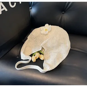 Close-up of off-white woven tote bag featuring hollow mesh pattern and 3D knitted flower