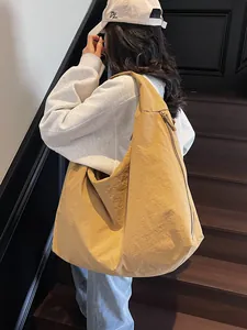 Large khaki hobo bag for women with minimalist nylon fabric shown on shoulder