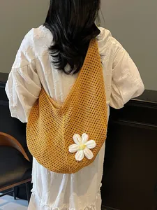Hollow out woven crochet shoulder bag in ginger yellow with a white floral charm