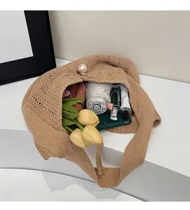 Top view of spacious interior of this handmade crochet tote bag with large pearl closure