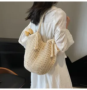 Detail of crochet knit shoulder bag with tassel fringe and hollow diamond pattern
