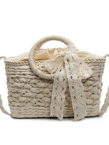 Handgefertigte Stroh-Handtasche mit eleganter Spitzenschleife und Kordelzug für den Strand