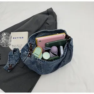 Top view of spacious denim tote bag interior showing capacity for tablet and daily items