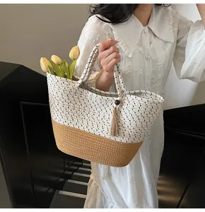 Detail of woven straw tote bag featuring polka dot pattern and wooden bead tassels