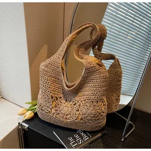 Detail of hand-woven straw hobo bag with sunflower crochet patterns and inner lining