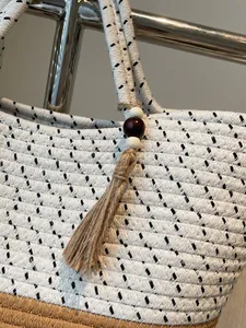 Handwoven white cotton rope tote bag with bohemian tassel and brown woven bottom