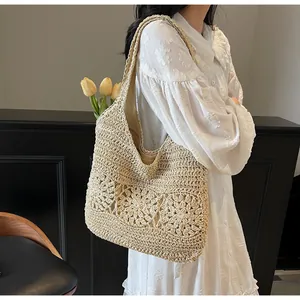 Close-up of woven shoulder bag with floral crochet hollow design and textile lining