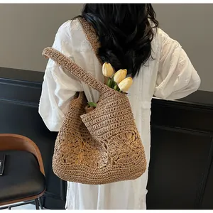 Detailed close-up of dark brown crochet tote bag featuring intricate floral woven patterns
