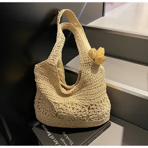 Detail of hollow floral crochet pattern on beige beach tote bag with cloth lining