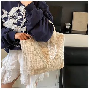 Detail showing herringbone weave texture and delicate white lace trim on woven tote bag