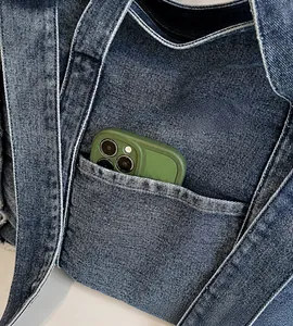 Close-up of blue denim tote bag with white contrast stitching and functional front pocket