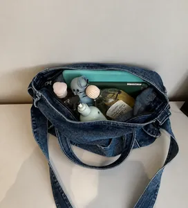 Top view of large capacity denim tote showing spacious interior with tablet and phone