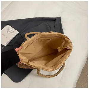 Dettaglio borsa shopper in paglia intrecciata con fodera in tessuto e tasca interna