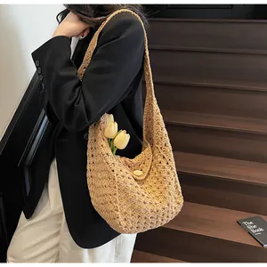 Detail of crochet hollow knit shoulder bag with natural wooden button closure