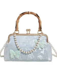 Blue jacquard shell bag with bamboo handle, butterfly accents, and pearl chain strap