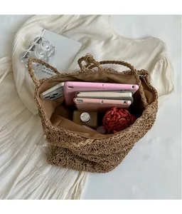 Macro shot of spacious inner compartment and hollow weave texture of the straw tote bag