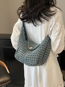 Handmade crochet cotton shoulder bag in blue with hollow weave and wooden button