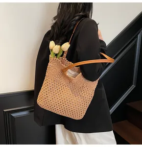 Detailed close-up of handmade woven tote bag with round crochet patterns and leather straps