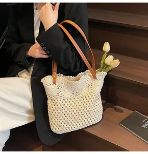 Detail of hollow woven tote bag with crochet floral patterns and leather shoulder straps
