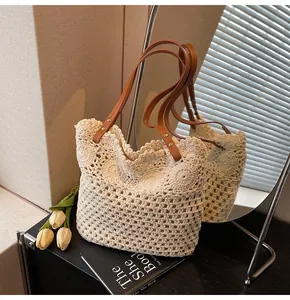 Close-up of hollow woven tote bag featuring cream crochet texture and leather straps