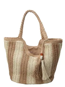 Summer straw tote bag with brown stripes, woven handles and tassel detail for beach travel