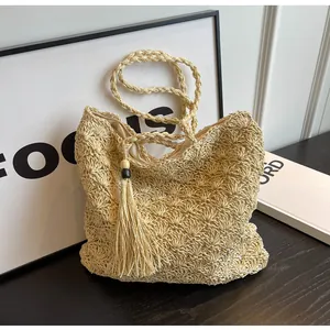 Detailed close-up of shell-shaped crochet texture with tassel charm and braided strap