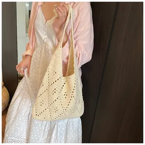 Detailed macro view of the cream crochet hollow-out pattern on this cotton woven tote bag