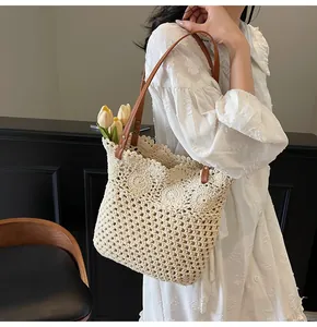 Detail of handwoven tote bag with crochet scalloped edges and brown leather shoulder straps