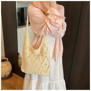 Detailed texture of beige hollow-out crochet shoulder bag for beach vacation style
