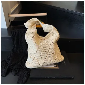 Close-up of ivory hollow crochet tote showing intricate handwoven diamond patterns