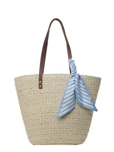 Woven straw bucket tote bag with brown faux leather handles and blue striped scarf