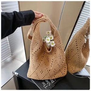 Detail of light brown crochet tote bag with hollow diamond pattern for beach vacation