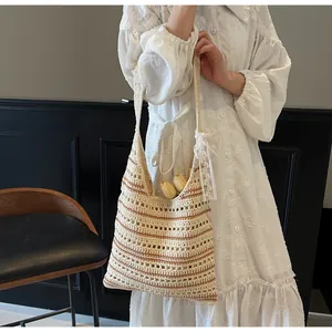 Detailed view of striped crochet tote bag with lace bow on model with white dress