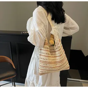 Detailed shoulder view of a striped crochet beach bag with a white lace bow detail