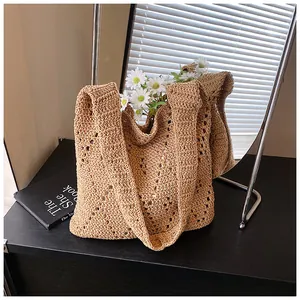 Close-up of khaki crochet shoulder bag featuring hollow diamond knit patterns and texture