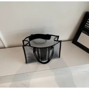 Top view of large transparent PVC tote bag with black leather straps and reinforced edges