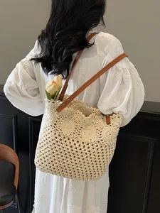 Woven hollow-out tote bag with brown leather straps and creamy white crochet patterns