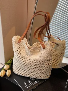 Handwoven hollow knit tote bag with brown leather handles and floral patterns for beach travel
