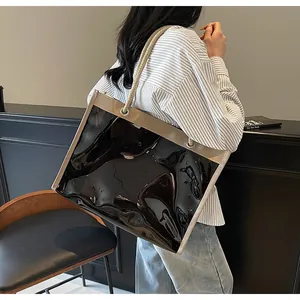 Detailed shot of large black transparent tote bag with rope handles and beige trim