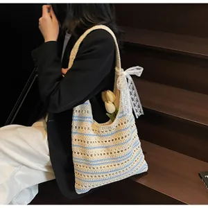 Detailed knit texture of beige striped crochet tote bag with white lace bow detail