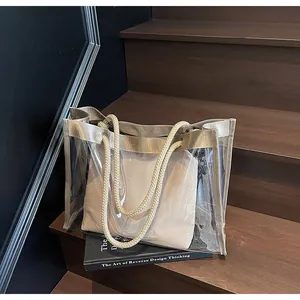 Detail of transparent PVC tote bag with beige canvas inner pouch and woven rope handles
