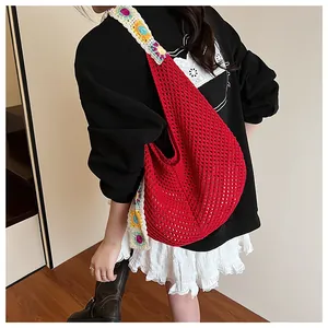Detail of red hollow crochet tote bag featuring colorful flower knit shoulder straps