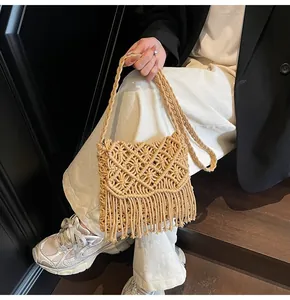 Detail view of a bohemian hand-woven mesh shoulder bag with fringe and woven strap