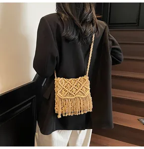 Detail of bohemian woven bag with long fringe tassels and sturdy braided strap