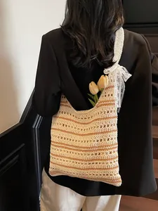 Hollow crochet tote bag with orange stripes and lace bow for summer beach vacation