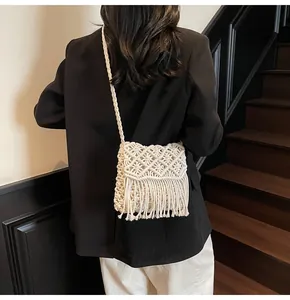 Detail shot of a white macrame woven bag with long tassels for bohemian style