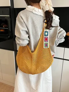 Handmade crochet knit tote bag in mustard yellow with colorful floral shoulder strap