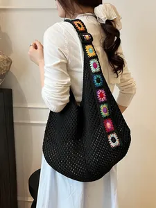 Black crochet tote bag with colorful floral strap and vintage knitted mesh texture