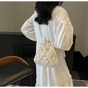Close-up of bohemian hollow-out crochet bucket bag with intricate diamond knit patterns